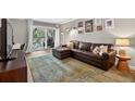 Comfortable living room with sliding doors to balcony, leather couch, and wood floors at 3325 Bayshore Blvd # A31, Tampa, FL 33629