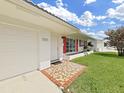 Inviting front exterior with red shutters, mosaic tile entryway and well-maintained lawn at 3515 100Th N Ter, Pinellas Park, FL 33782