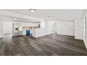 Spacious living area featuring modern gray wood floors and an open layout at 3614 Vasco St, Punta Gorda, FL 33950
