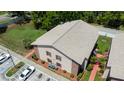 The building exhibits a tan facade with brick accents, complementing its shingled roof in this aerial view at 4015 My Lady Ln # 7, Land O Lakes, FL 34638