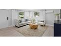 Bright living room with modern decor, large windows, and stylish furniture, creating a cozy atmosphere at 4300 Maple Ne St, St Petersburg, FL 33703