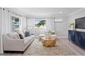 Inviting living room featuring contemporary furnishings, wood-look floors, and bright natural light at 4300 Maple Ne St, St Petersburg, FL 33703