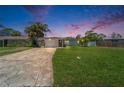 Charming single-story home at dusk with manicured lawn and stone driveway at 4518 Helena Ne St, St Petersburg, FL 33703