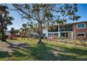 A large tree shades the lawn and condo's screened in porches at Lake Overlook Condominiums at 4580 Overlook Ne Dr # 191, St Petersburg, FL 33703