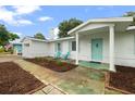 This home has colorful shutters, a white facade, and a welcoming entryway at 4753 58Th N St, Kenneth City, FL 33709