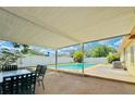 Relaxing backyard featuring a sparkling pool, covered patio area, and ample seating for outdoor enjoyment at 4906 N Arrawana Ave, Tampa, FL 33614