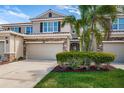 Beautiful two story home features a two car garage, stone accents, manicured lawn and mature palm trees at 575 53Rd N Ave, St Petersburg, FL 33703