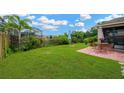 Expansive backyard with lush lawn, mature trees and privacy fence at 5806 Tulip Flower Dr, Riverview, FL 33578