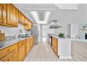 Modern kitchen with stainless steel appliances, stone countertops, and ample cabinet space at 6204 Walsh Ln, Tampa, FL 33625