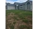 Charming single Gathering home with an attached two car garage, attractive architecture, and front yard at 7056 Landover Blvd, Spring Hill, FL 34608