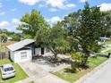 Charming home featuring a well-maintained lawn and mature trees at 8233 44Th St N N St, Pinellas Park, FL 33781