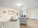 Inviting living room with wood-look floors and neutral walls at 8233 44Th St N N St, Pinellas Park, FL 33781