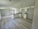 Bright, open kitchen with white cabinets, granite countertops and stainless steel faucet at 9053 Bourbon St, New Port Richey, FL 34654