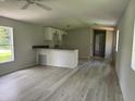 Bright and airy living room featuring durable flooring and modern finishes at 9053 Bourbon St, New Port Richey, FL 34654