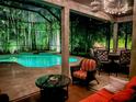 Inviting screened-in patio offers a luxurious pool and comfortable outdoor seating for relaxation and entertainment at 10675 Park Place Dr, Largo, FL 33778