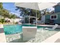 Beautiful backyard pool area with lounge chairs and a covered outdoor bar at 112 E Plymouth St, Tampa, FL 33603