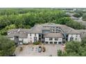 Aerial view showcasing the apartment complex surrounded by lush greenery and landscaping at 12912 Arbor Isle Dr # 202, Temple Terrace, FL 33637