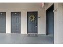 Apartment entryway featuring unit doors, stairway access, and outdoor welcome mat at 12912 Arbor Isle Dr # 202, Temple Terrace, FL 33637