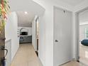 Bright apartment entryway featuring tile floors and view to the living room and bedroom at 12912 Arbor Isle Dr # 202, Temple Terrace, FL 33637