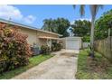 View of home showing driveway leading to detached garage and view of front entrance at 1533 Suffolk N St, St Petersburg, FL 33710