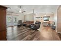 Open-concept living room with wood floors, high ceilings, and access to the outdoor area at 22422 Stillwood Dr, Land O Lakes, FL 34639