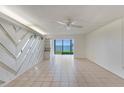 Bright, airy living room featuring neutral tile floors and scenic water view at 2980 Haines Bayshore Rd # 105, Clearwater, FL 33760