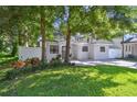 Inviting single-story home with lush green landscaping, brick paved driveway, and a welcoming front porch entrance at 3127 W Oakellar Ave, Tampa, FL 33611