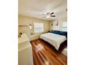 Sunlit bedroom boasts a queen-sized bed, wood floors, and tranquil decor, creating a restful atmosphere at 3135 33Rd N Ave, St Petersburg, FL 33713