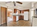 Functional kitchen with wood cabinets, granite countertops, and white appliances at 4025 Chesswood Dr, Holiday, FL 34691