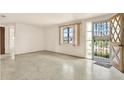 Bright living room features a decorative front door, a large window and concrete floors at 4025 Chesswood Dr, Holiday, FL 34691