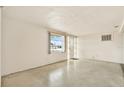 Bright living room features a decorative front door, a large window and concrete floors at 4025 Chesswood Dr, Holiday, FL 34691