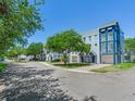 Street view of multiple light blue condo buildings with garages and balconies on a sunny day at 4503 Legacy Park Dr, Tampa, FL 33611