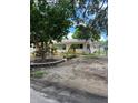 Quaint single-story house with well-maintained lawn, mature trees, and a fenced backyard at 4720 Coronado S Way, Gulfport, FL 33711