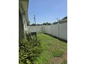 Narrow fenced backyard with green ground cover and some foliage at 534 N Larry Cir, Brandon, FL 33511