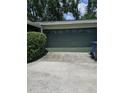 View of the paneled garage door with adjacent trash cans on the driveway at 534 N Larry Cir, Brandon, FL 33511