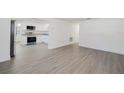 Spacious living room with newly installed light gray flooring and plenty of natural light at 7516 S Obrien St, Tampa, FL 33616