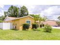 Spacious backyard with a well-manicured lawn, providing an ideal outdoor living space at 7542 Armand Cir, Tampa, FL 33634