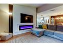 Stylish living room featuring a modern fireplace, sleek TV, and comfortable seating at 9481 Highland Oak Dr # 1308, Tampa, FL 33647