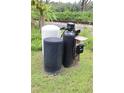 Outside well system with multiple tanks and components on a grassy lot at 1006 Gray St, Plant City, FL 33563