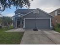 Attractive house with a two-car garage, green lawn, and a basketball hoop in the driveway at 10109 36Th E Ct, Parrish, FL 34219