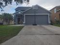 Charming home with a spacious driveway, a basketball hoop, and a meticulously maintained front lawn at 10109 36Th E Ct, Parrish, FL 34219