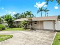 Charming single-story home with well-maintained lawn, mature palms, and a spacious driveway at 11460 Park Blvd, Seminole, FL 33772