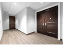 Hallway with hardwood floor and doors in neutral paint color scheme at 1209 E Cumberland Ave # 2703, Tampa, FL 33602