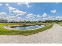 Scenic view of a tranquil pond with a walking path, offering a serene outdoor escape at 13304 Mylion Way, Spring Hill, FL 34610