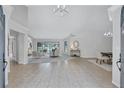 Open-concept living room with tile floors, a view of the pool, and an adjacent dining area at 134 Barrington Dr, Brandon, FL 33511