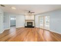 Open living room featuring wood floors, fireplace, and doors to the pool deck at 1517 60Th S St, Gulfport, FL 33707