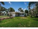Well-manicured front yard and landscaping highlight this charming single-story home with a white brick facade at 1700 Shore Acres Ne Blvd, St Petersburg, FL 33703
