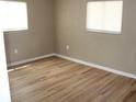 Bright bedroom with hardwood floors and natural light from two large windows at 208 Wilson Ave, Brooksville, FL 34601