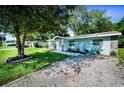 Well-manicured lawn and stone accents enhance this home's curb appeal with ample driveway parking at 2121 Dodge St, Clearwater, FL 33760