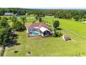 Backyard aerial view featuring a screened-in pool and patio area at 23075 Hayman Rd, Brooksville, FL 34602